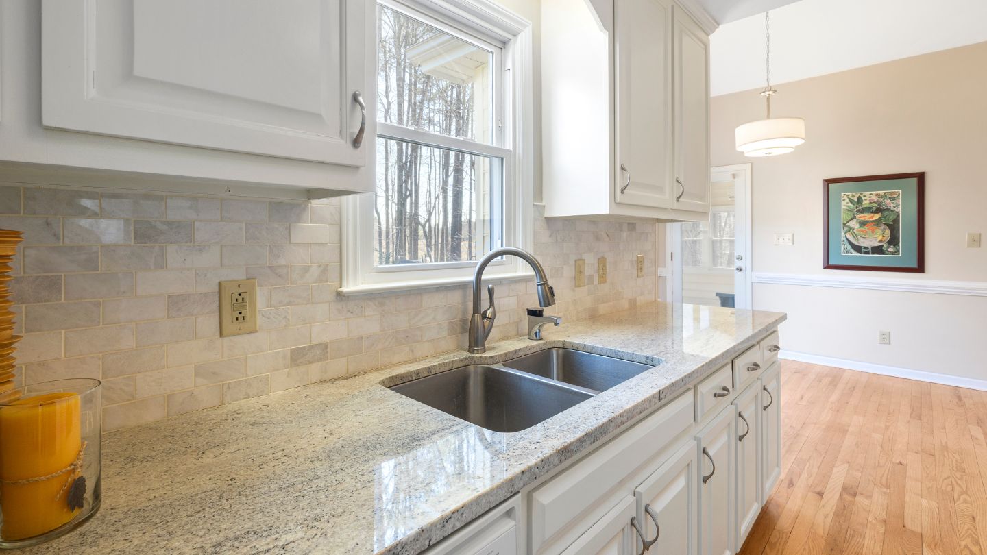 Quartz countertops and full slab backsplash installed by kitchen remodeling in Tampa Bay professionals