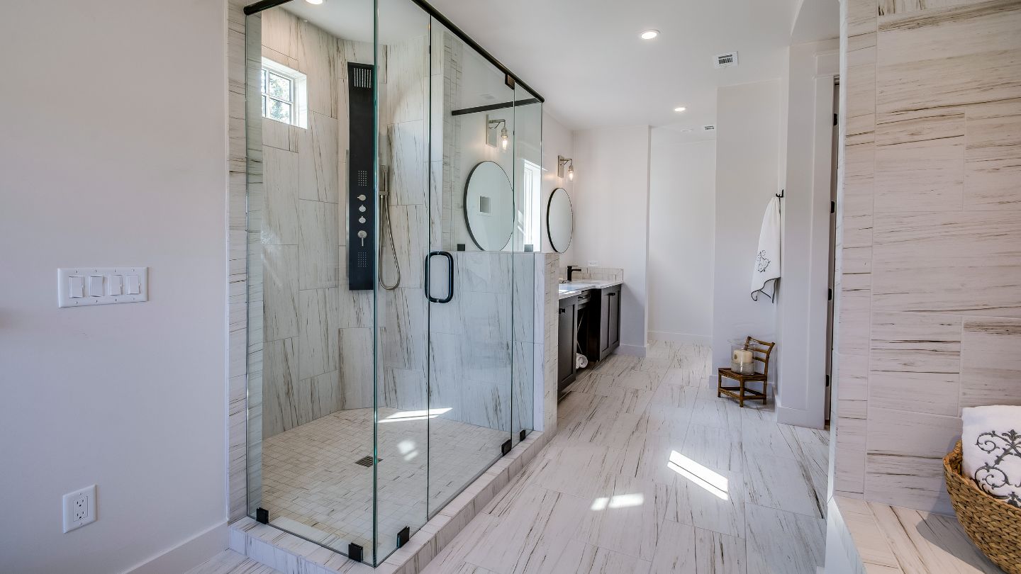 Bathroom renovation with walk-in shower and marble tile walls