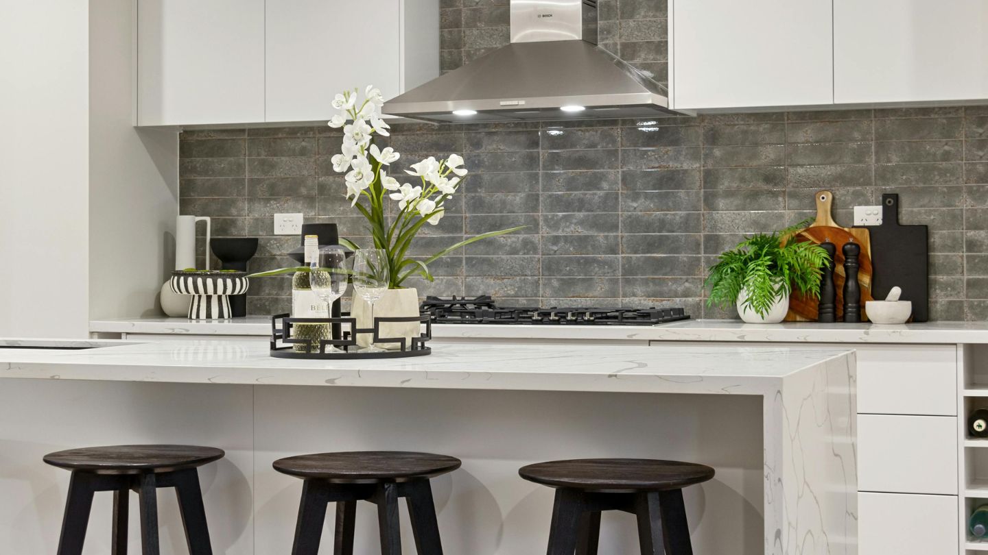 Kitchen backsplash installation with modern gray tile design